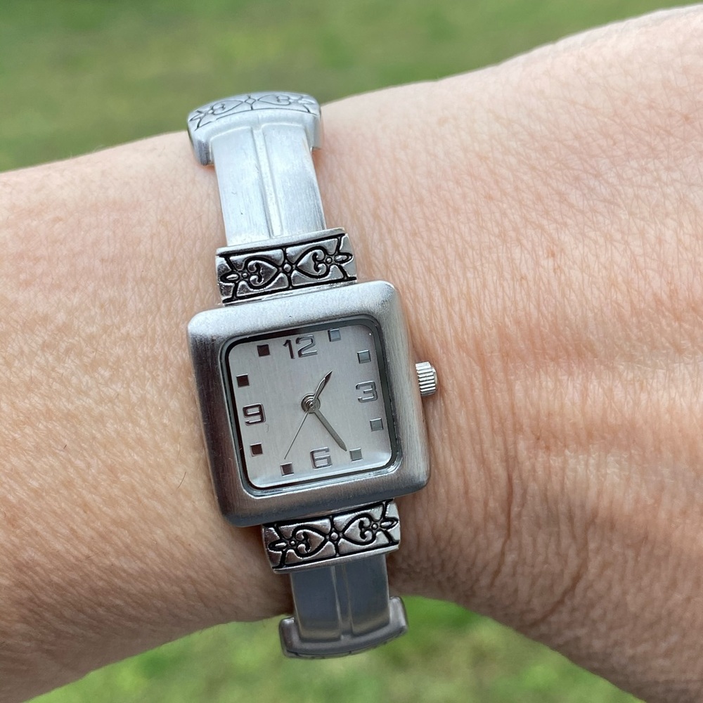 Silver tone cuff watch heart design accents